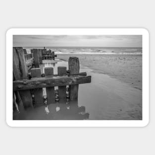 Wooden sea defences protecting the beach from coastal erosion Sticker